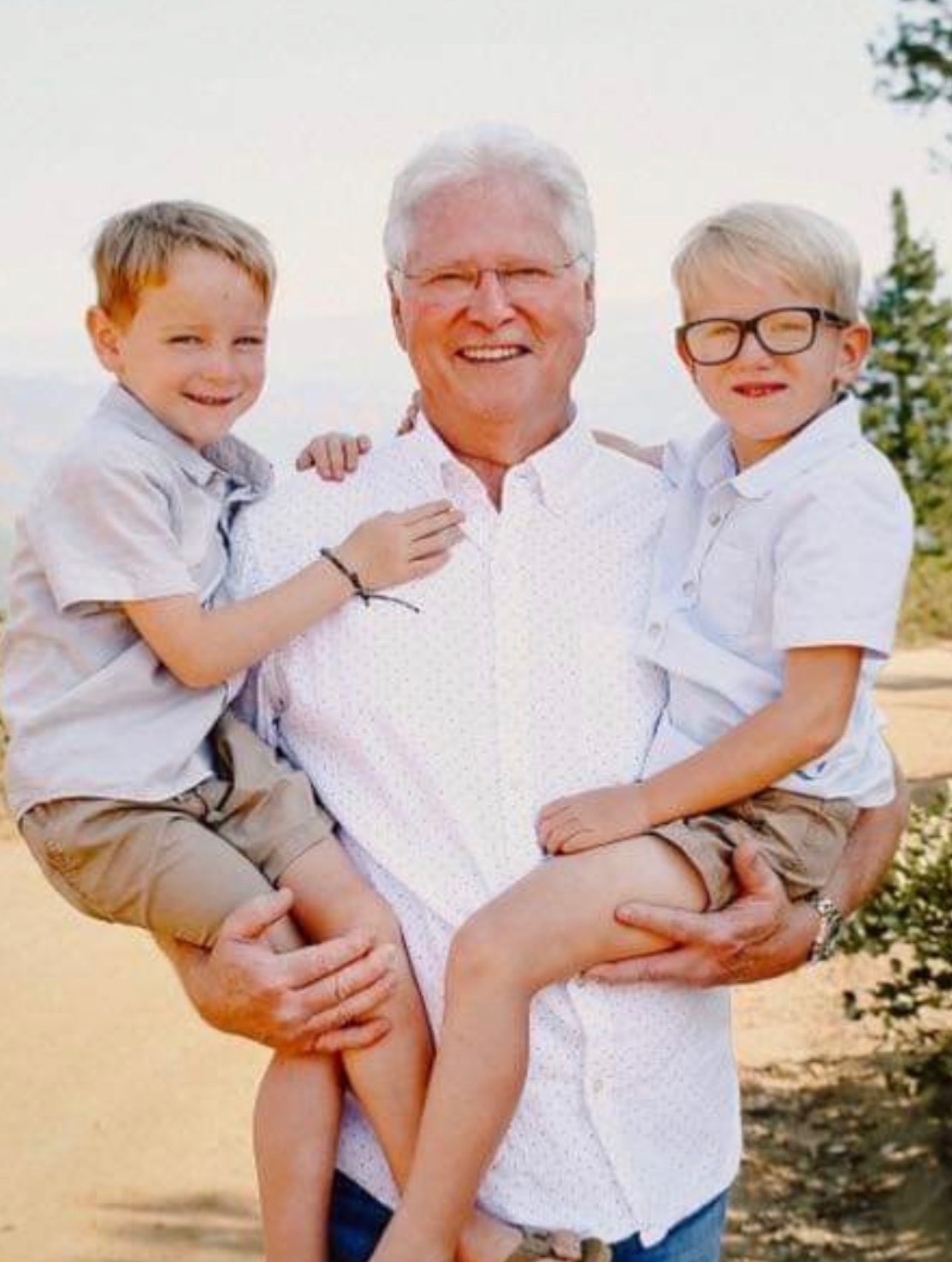 Randall Vickrey holding grandsons smiling